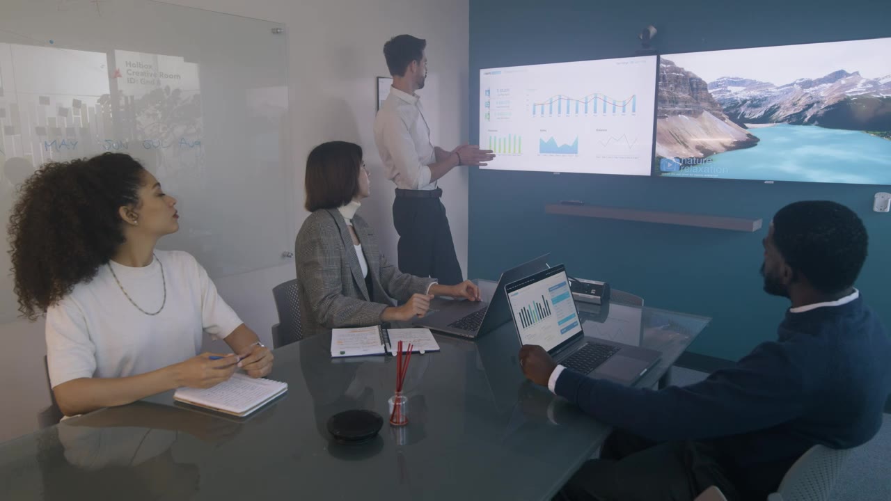 A presenter sharing charts with colleagues
