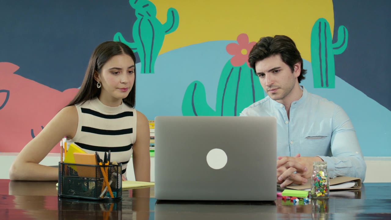 Two colleagues working together at a laptop